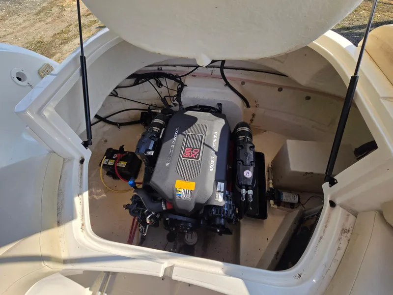 Slide: The Image of 2005 Chaparral 236 Sunesta boat engine compartment with visible motor components. - 19