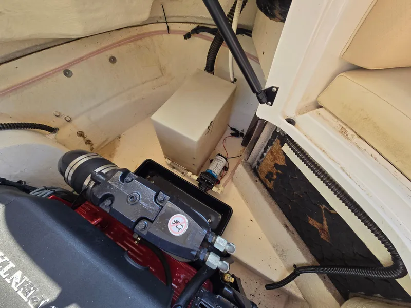 Slide: The Image of Engine compartment of 2005 Chaparral 236 Sunesta boat, showing mechanical components and seating area. - 20