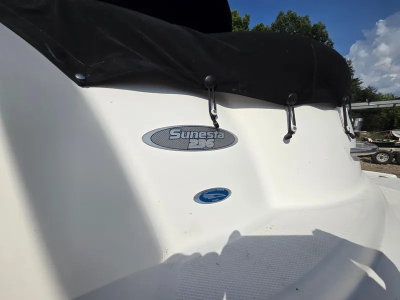 Slide: The Image of 2005 Chaparral 236 Sunesta boat with black cover and logo in sunlight. - 25