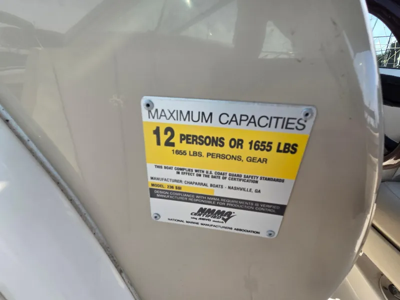 Slide: The Image of 2005 Chaparral 236 Sunesta capacity plate: 12 persons or 1655 lbs maximum. - 33