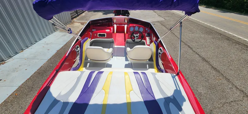 Slide: The Image of 2005 Baja 202 Islander boat with vibrant interior and canopy on a sunny day. - 10