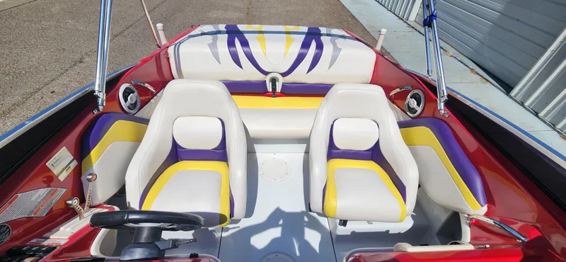 Slide: The Image of 2005 Baja 202 Islander boat interior with colorful seating and steering wheel. - 12
