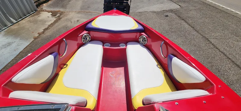 Slide: The Image of 2005 Baja 202 Islander boat interior with red, white, and yellow seating. - 13