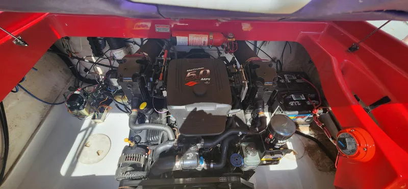 Slide: The Image of 2005 Baja 202 Islander engine compartment with MerCruiser motor and red accents. - 15