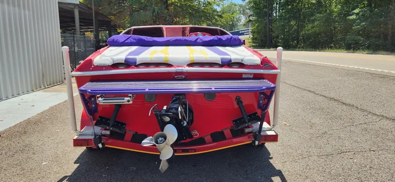 Slide: The Image of 2005 Baja 202 Islander boat, rear view, vibrant colors, parked on a sunny day. - 4
