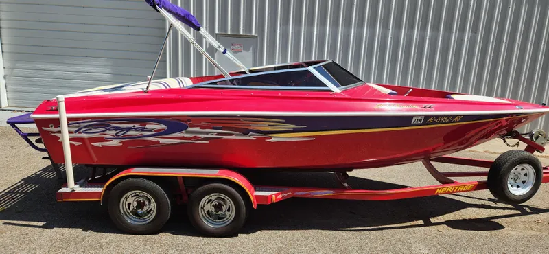 Slide: The Image of Red 2005 Baja 202 Islander speedboat on trailer, parked outdoors. - 8