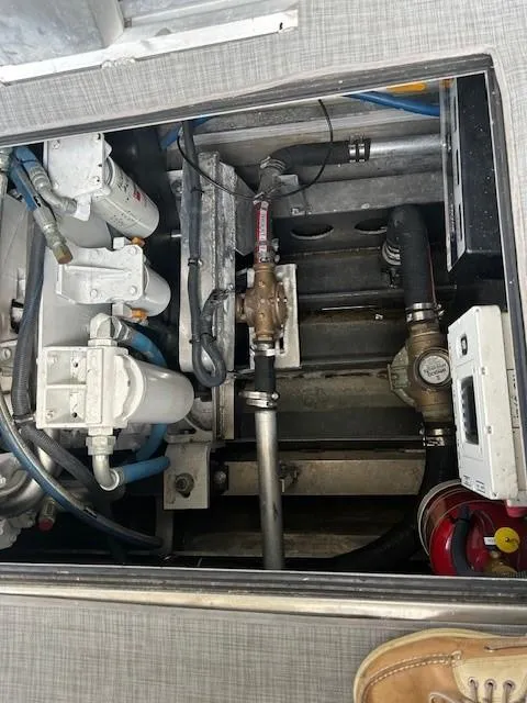 Slide: The Image of Engine compartment of 2023 Smoky Mountain Asymmetrical foil-assisted catamaran, showing mechanical components and wiring. - 10