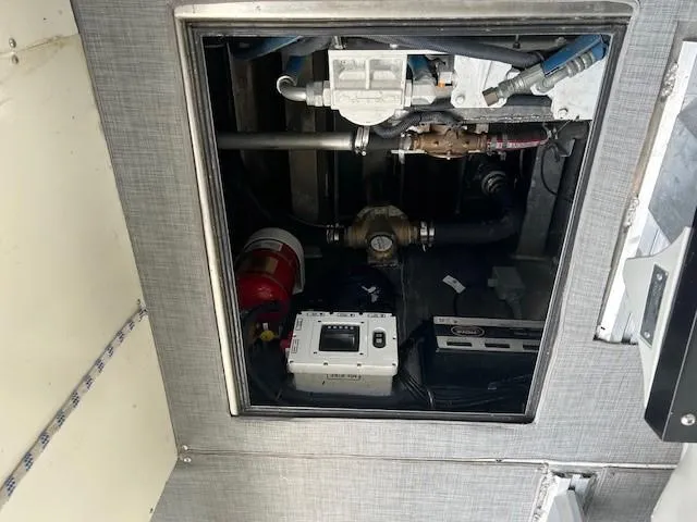 Slide: The Image of Engine compartment of 2023 Smoky Mountain asymmetrical foil-assisted catamaran, showing mechanical components. - 11