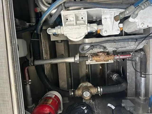Slide: The Image of Engine compartment of 2023 Smoky Mountain asymmetrical foil-assisted catamaran, featuring pipes and fire extinguisher. - 14