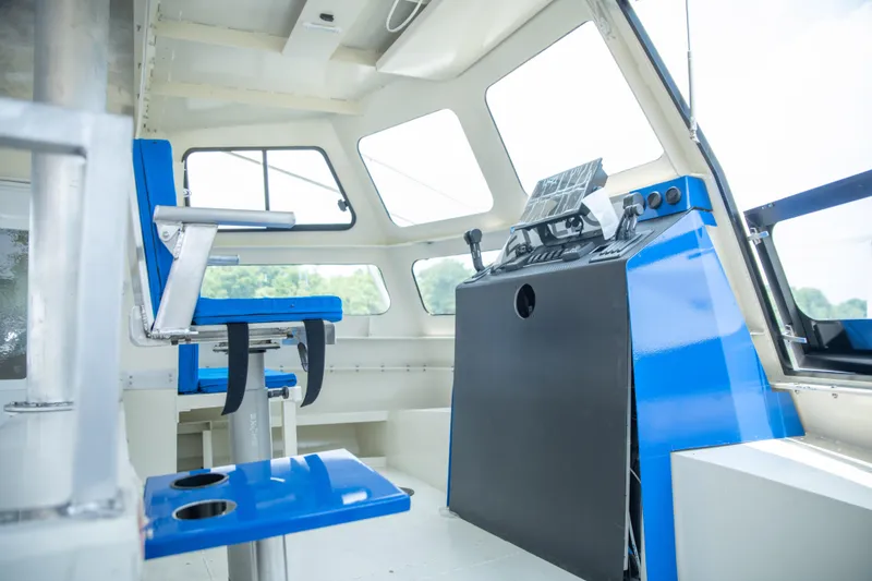 Slide: The Image of Interior of 2023 Smoky Mountain asymmetrical foil-assisted catamaran, featuring blue seating and control panel. - 4