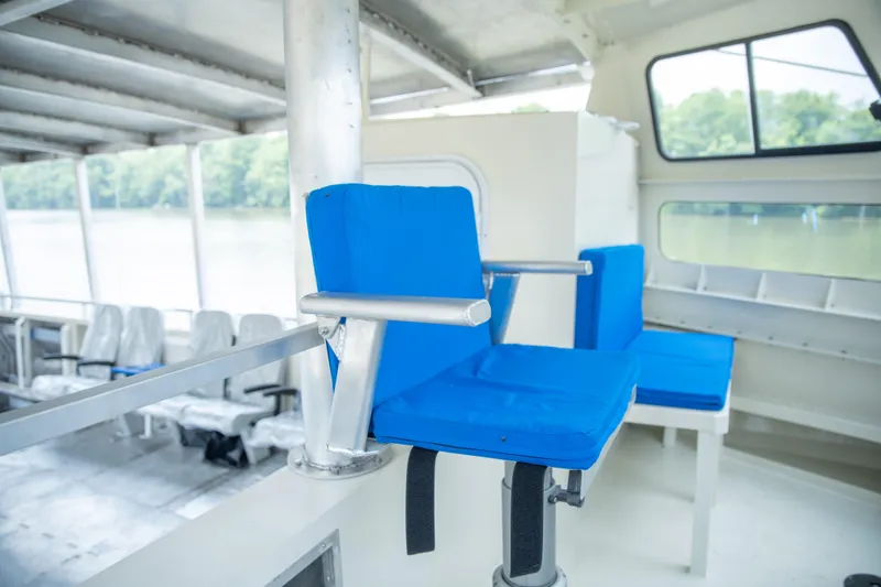 Slide: The Image of Interior of 2023 Smoky Mountain catamaran with blue seating and large windows. - 5