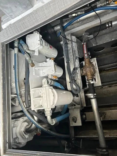 Slide: The Image of Engine compartment of 2023 Smoky Mountain asymmetrical foil-assisted catamaran, showing mechanical components and hoses. - 9