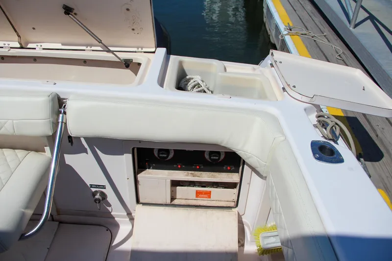 Slide: The Image of 2003 Grady-White Express 330 boat interior with storage compartments and seating. - 11