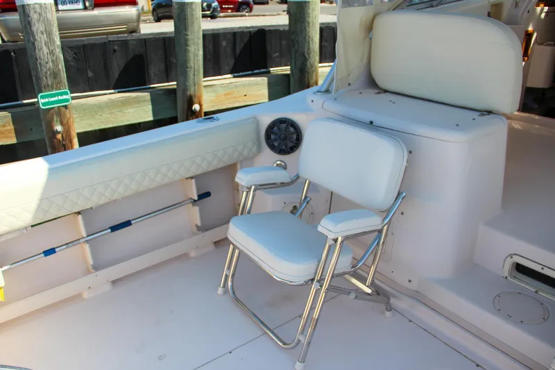 Slide: The Image of 2003 Grady-White Express 330 boat interior with white seating and fishing rod holders. - 14