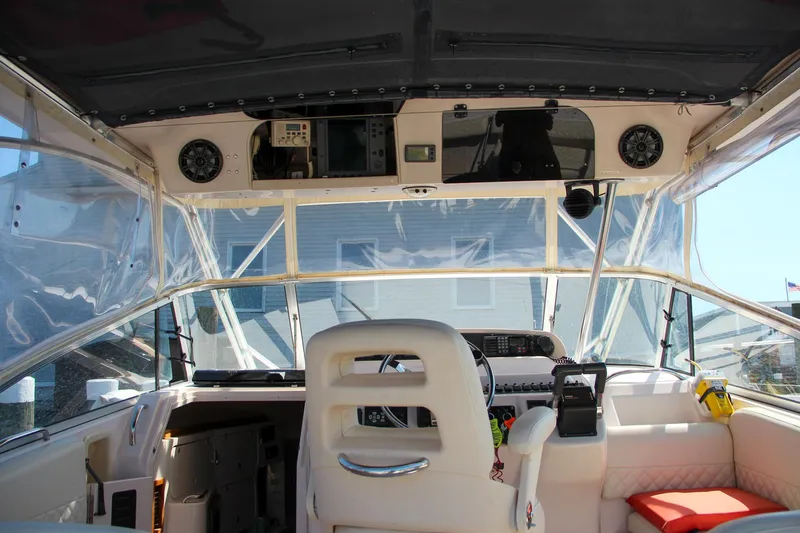 Slide: The Image of Interior view of 2003 Grady-White Express 330 boat cockpit with seating and controls. - 18