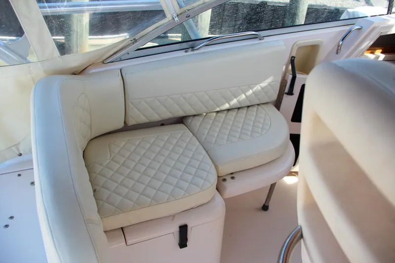 Slide: The Image of 2003 Grady-White Express 330 boat interior with white cushioned seating. - 19