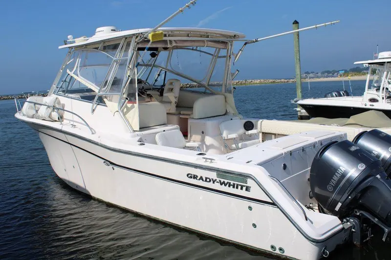 Slide: The Image of 2003 Grady-White Express 330 boat docked with twin Yamaha engines. - 2