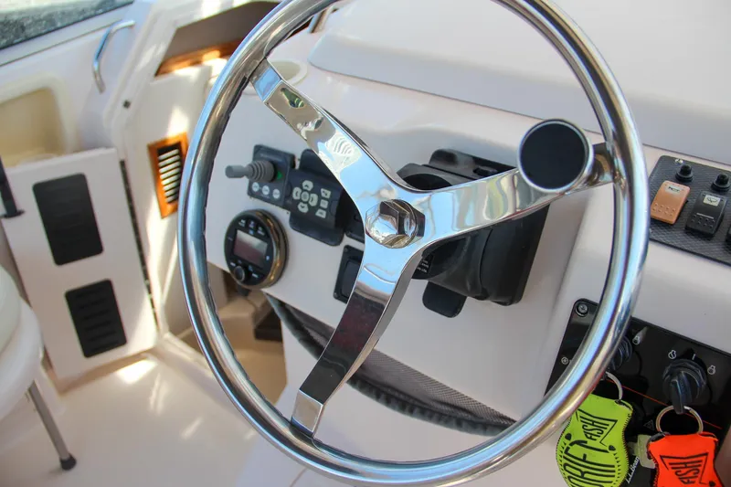 Slide: The Image of Steering wheel of 2003 Grady-White Express 330 boat cockpit. - 24