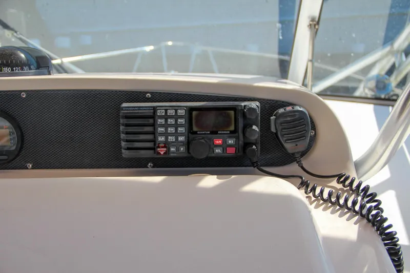 Slide: The Image of 2003 Grady-White Express 330 boat dashboard with radio and microphone. - 25