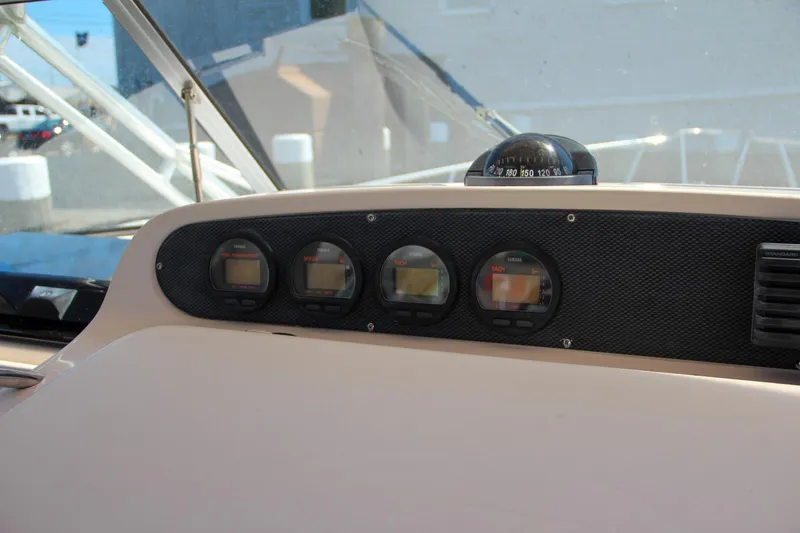 Slide: The Image of Dashboard of a 2003 Grady-White Express 330 boat with navigation instruments. - 26
