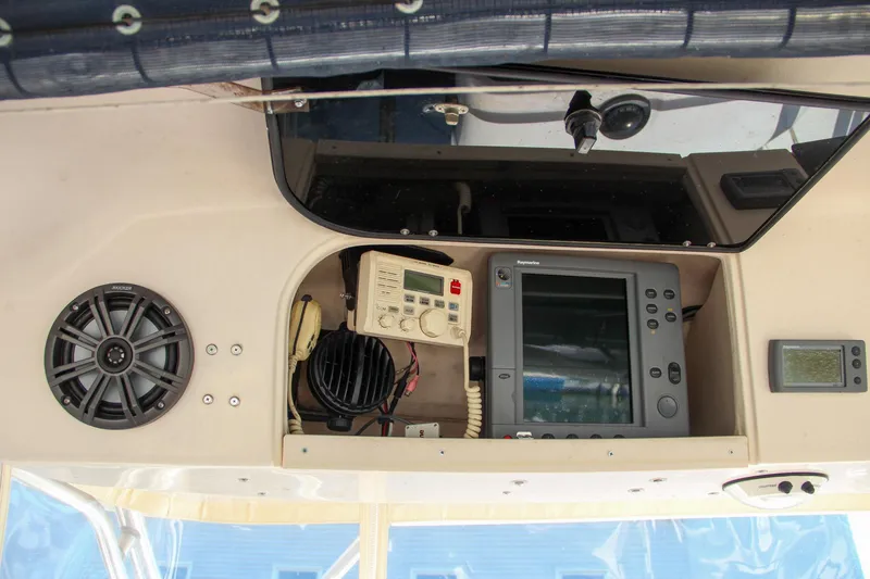 Slide: The Image of 2003 Grady-White Express 330 boat dashboard with navigation equipment and speaker. - 29