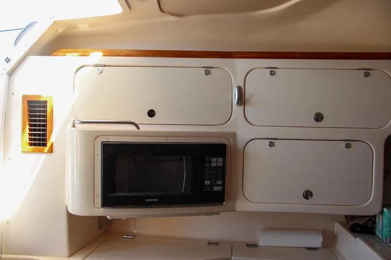 Slide: The Image of 2003 Grady-White Express 330 interior with microwave and storage cabinets. - 35