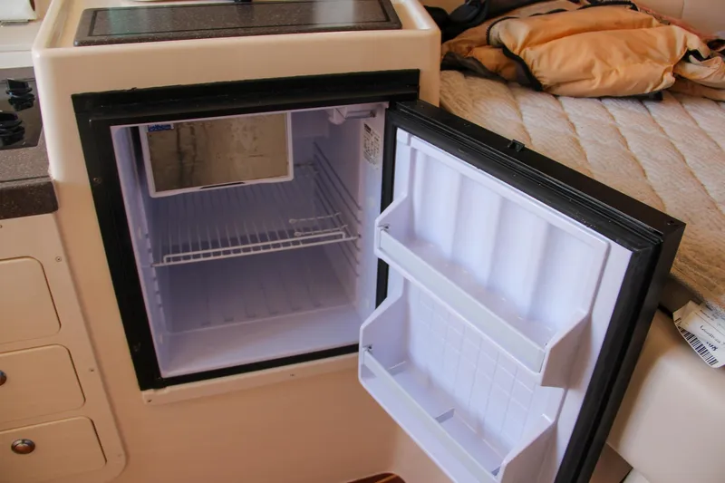 Slide: The Image of Open fridge inside 2003 Grady-White Express 330 boat cabin. - 37