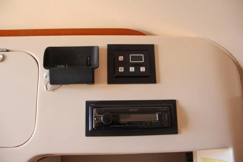 Slide: The Image of Control panel and stereo system in 2003 Grady-White Express 330 boat interior. - 38