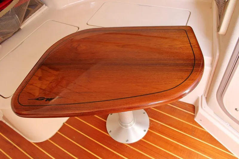 Slide: The Image of Wooden table on 2003 Grady-White Express 330 boat with polished finish. - 42