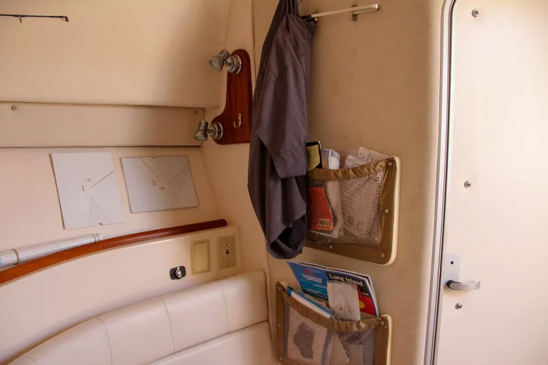 Slide: The Image of Interior of 2003 Grady-White Express 330 boat with storage pockets and hanging jacket. - 45