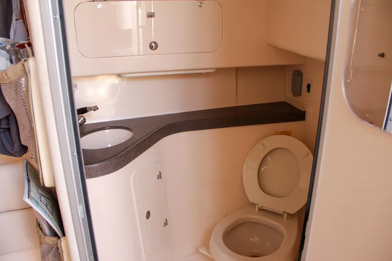 Slide: The Image of 2003 Grady-White Express 330 boat bathroom with sink and toilet. - 48