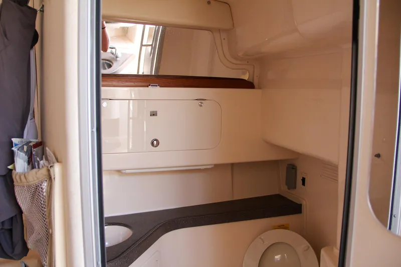 Slide: The Image of 2003 Grady-White Express 330 boat interior bathroom with storage and toilet. - 49