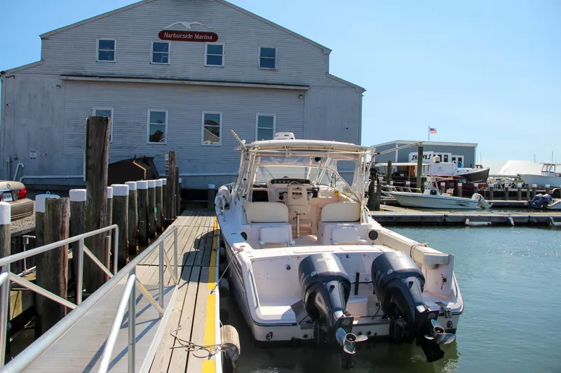 Slide: The Image of 2003 Grady-White Express 330 docked at a marina with twin engines. - 5