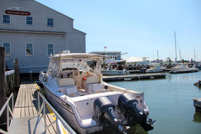 Slide: The Image of 2003 Grady-White Express 330 docked at a marina with clear skies. - 7