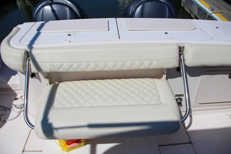 Slide: The Image of 2003 Grady-White Express 330 boat seat with quilted upholstery and metal supports. - 9