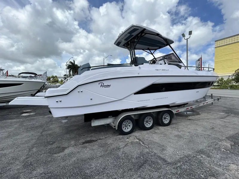 Slide: The Image of 2025 Ranieri 330LX boat on trailer under cloudy sky. - 12