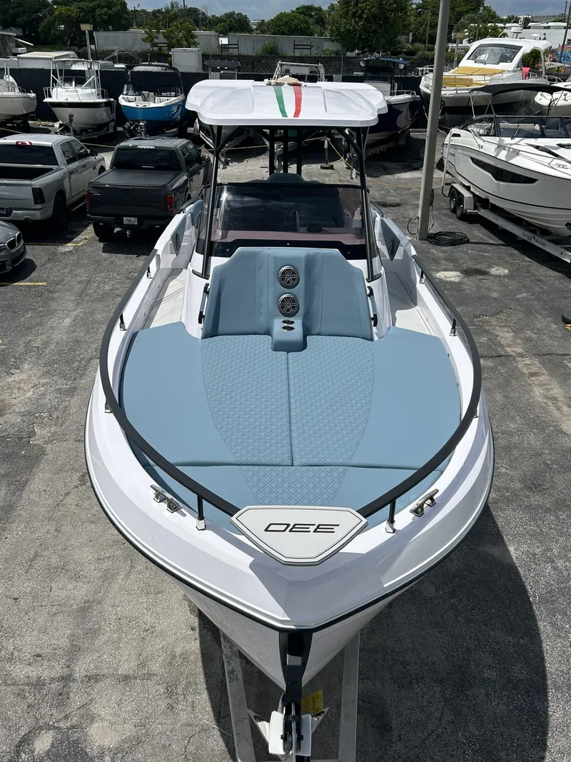 Slide: The Image of 2025 Ranieri 330LX boat with sleek design, docked among other vessels. - 26