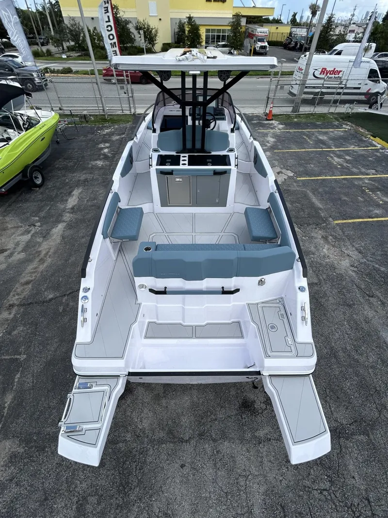 Slide: The Image of 2025 Ranieri 330LX boat with spacious deck and modern seating, parked outdoors. - 27