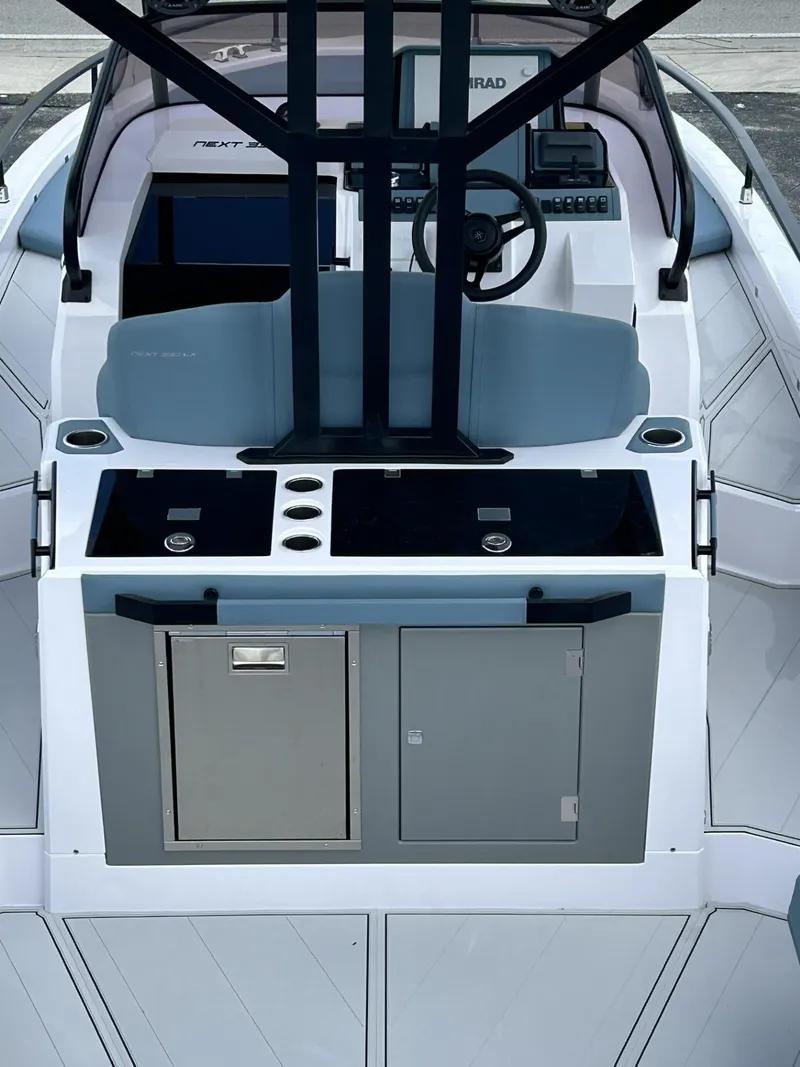 Slide: The Image of 2025 Ranieri 330LX boat interior with modern helm and storage compartments. - 29