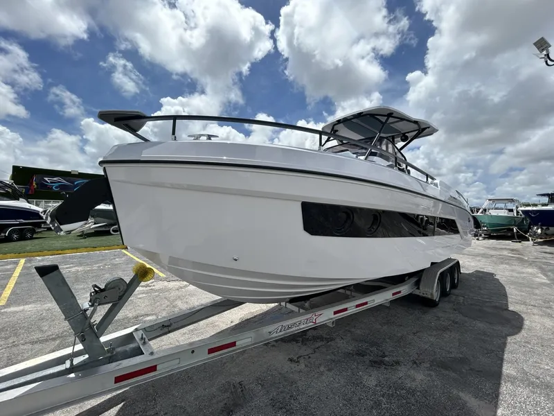 Slide: The Image of 2025 Ranieri 330LX boat on trailer under cloudy sky. - 3