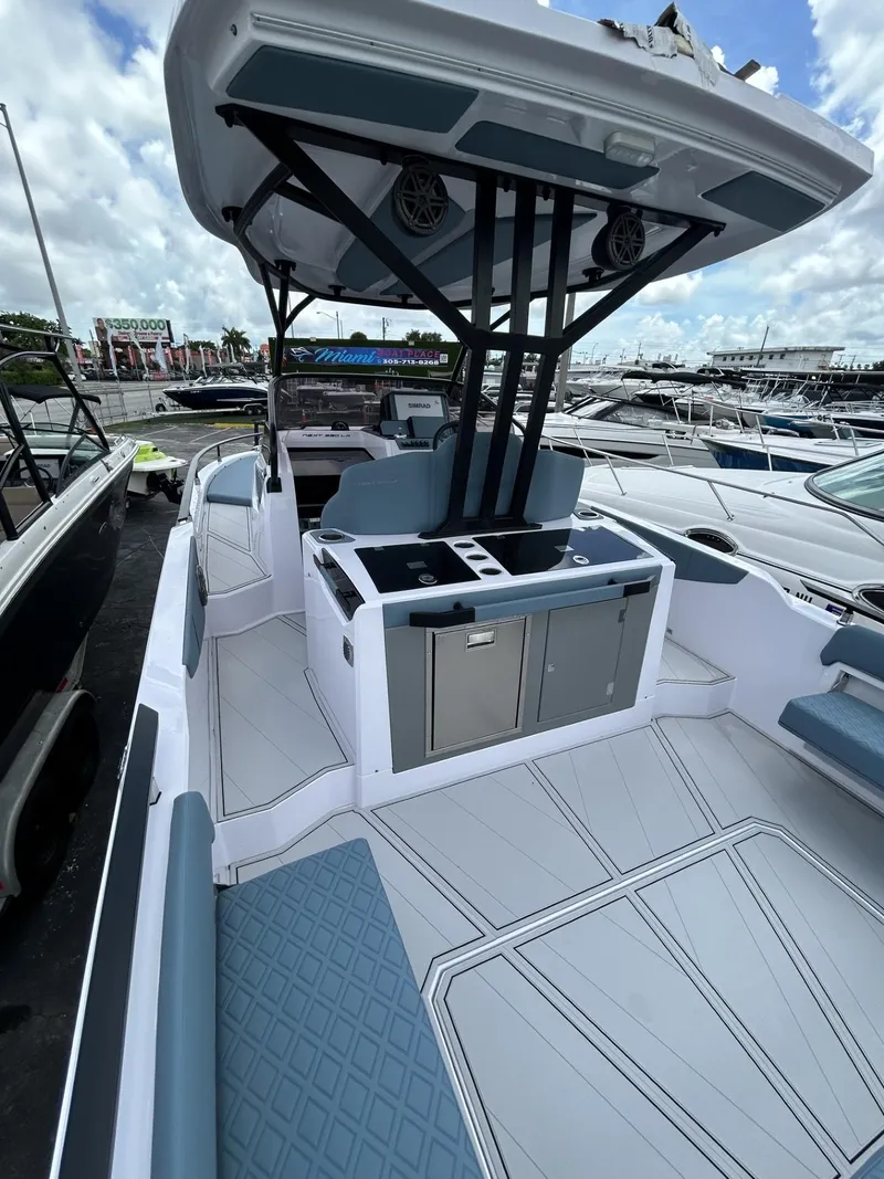 Slide: The Image of 2025 Ranieri 330LX boat with sleek design and modern amenities docked at marina. - 33