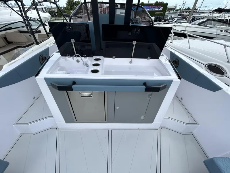 Slide: The Image of 2025 Ranieri 330LX boat interior with modern sink and storage area. - 36