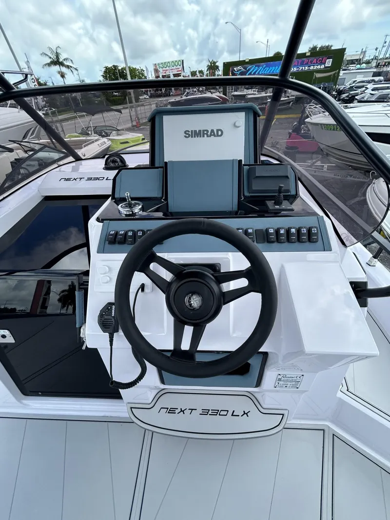 Slide: The Image of 2025 Ranieri 330LX boat dashboard with Simrad navigation system. - 37