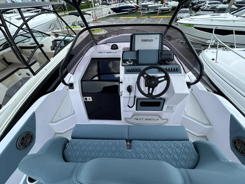Slide: The Image of 2025 Ranieri 330LX boat cockpit with modern navigation system and luxurious seating. - 38