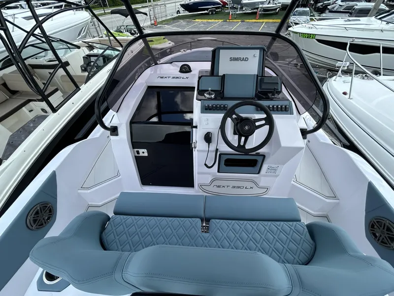 Slide: The Image of 2025 Ranieri 330LX boat cockpit with modern controls and blue seating. - 39