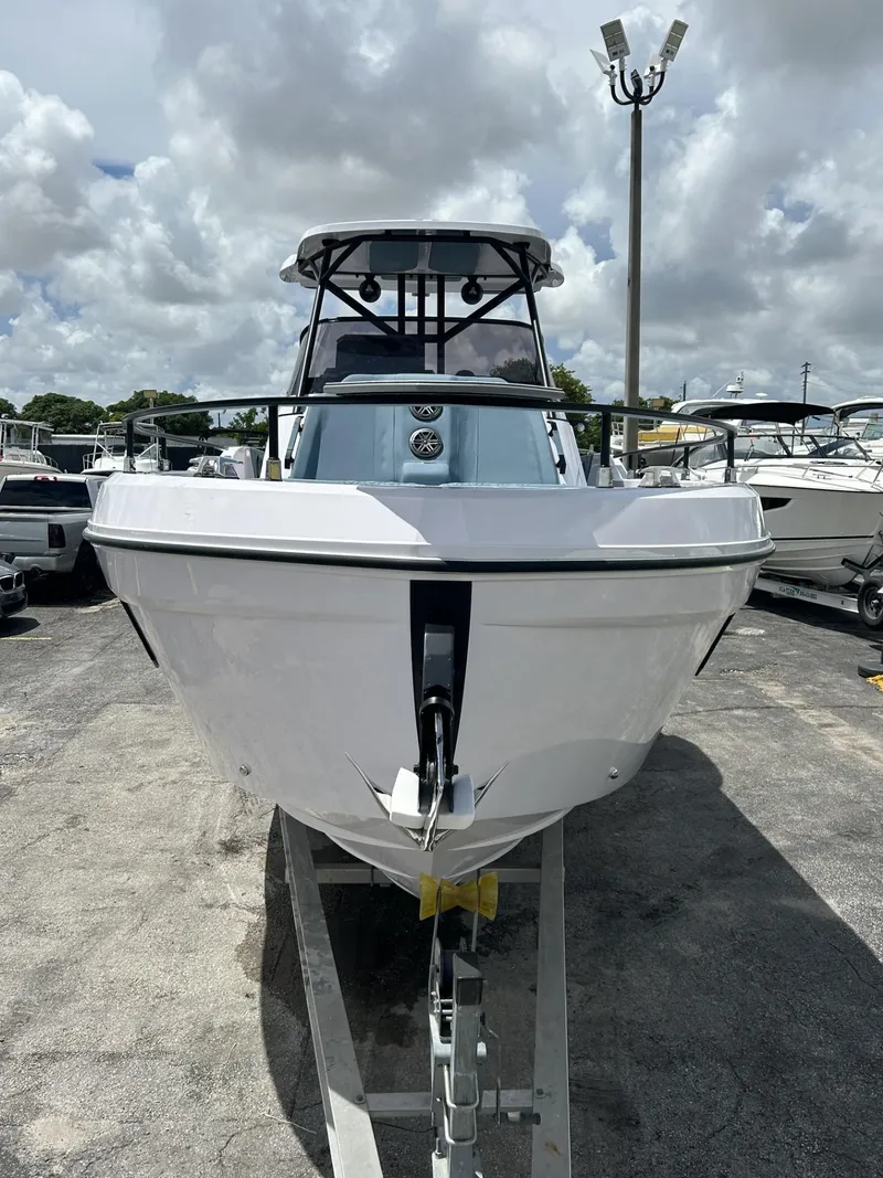 Slide: The Image of 2025 Ranieri 330LX boat on trailer under cloudy sky. - 4