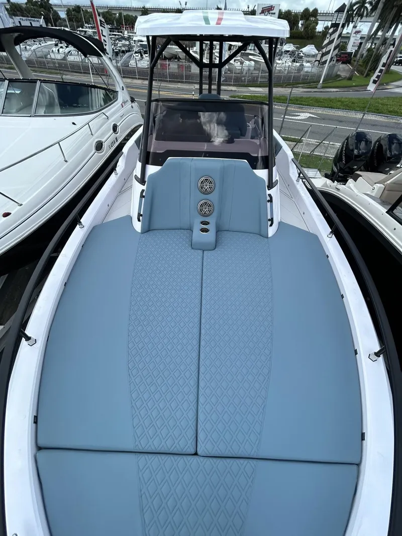 Slide: The Image of 2025 Ranieri 330LX boat with blue deck, docked in marina. - 41
