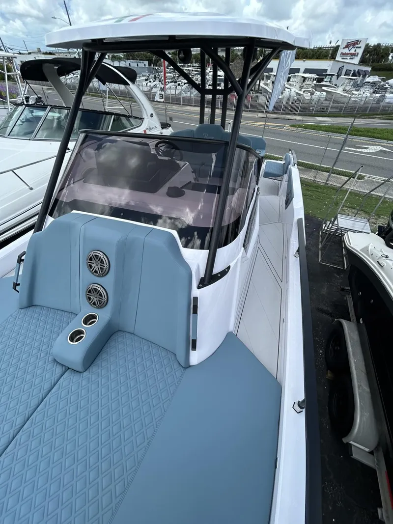 Slide: The Image of 2025 Ranieri 330LX boat with sleek design and modern features at a marina. - 42