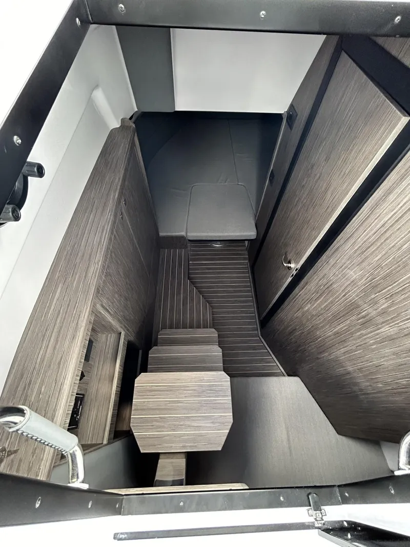 Slide: The Image of Interior of 2025 Ranieri 330LX boat, featuring modern wood finish and compact design. - 45