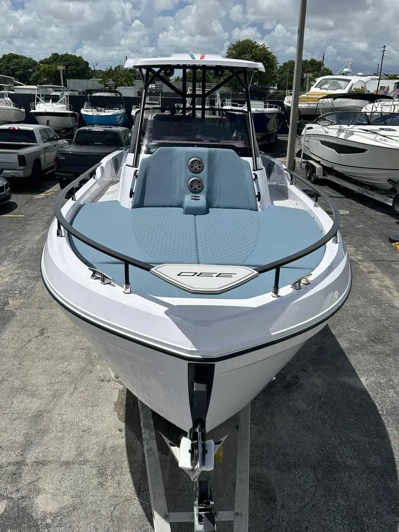 Slide: The Image of 2025 Ranieri 330LX boat, sleek design, parked in a marina under cloudy skies. - 5